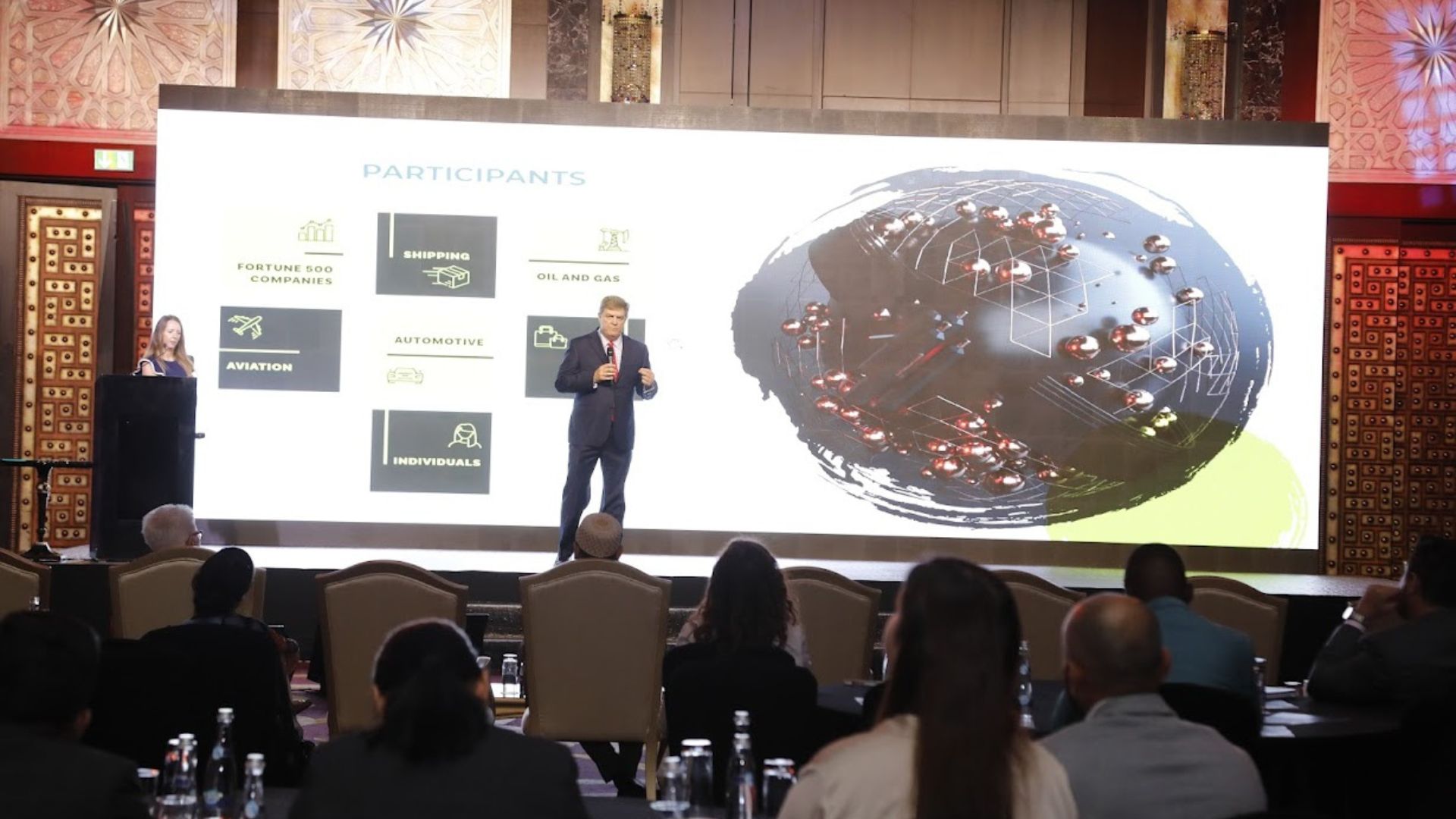 A presentation on stage before a seated audience