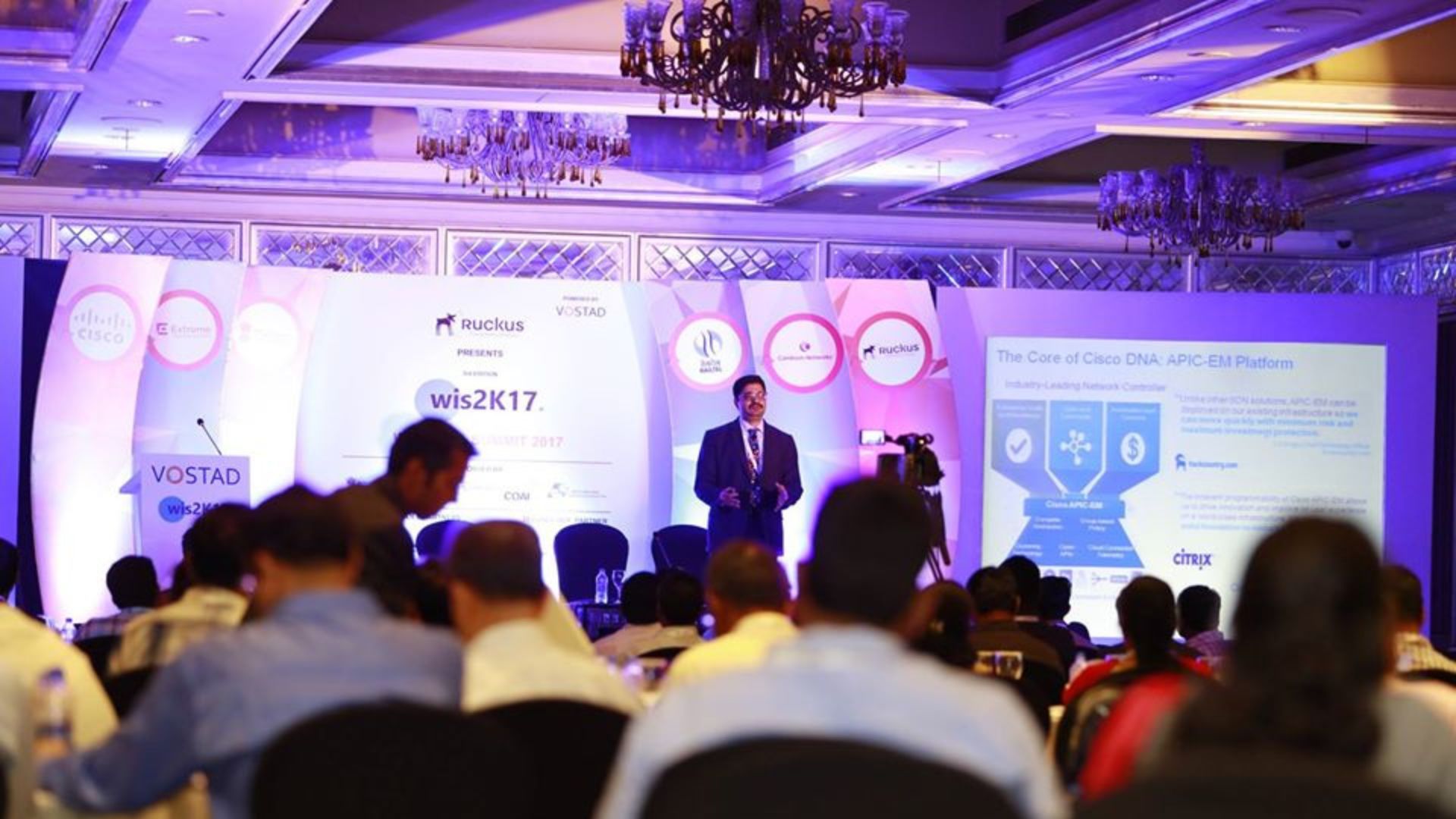 A summit session under way in a full ballroom