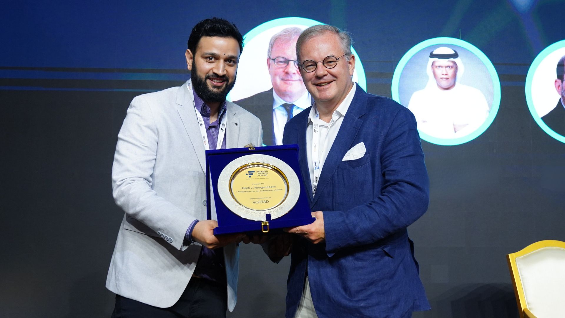 A commemorative plaque presented to a speaker on stage