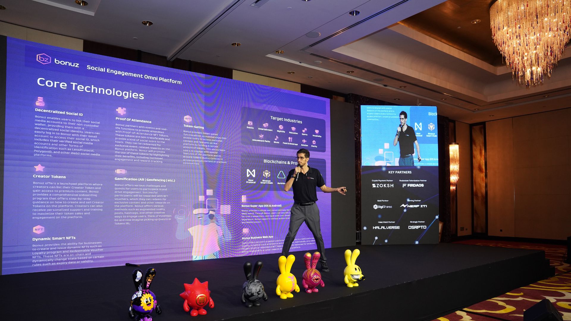 A presentation under way on a large stage screen