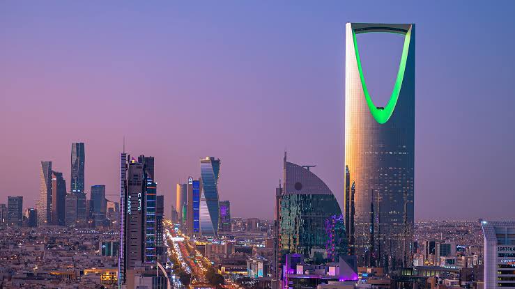 The Riyadh skyline at dusk, with the Kingdom Centre tower above the city